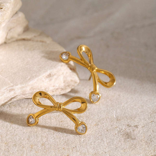 earringsAdd a touch of cultural elegance with these exquisite bow earrings, beautifully designed with a traditional Indian flair. Crafted with 18K gold-plated stainless steeJeena Earrings